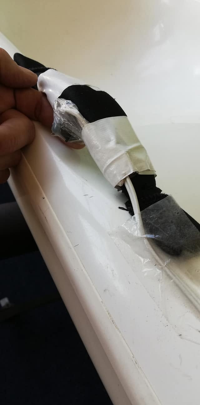 Rocker switch in a plastic bag under the side handle