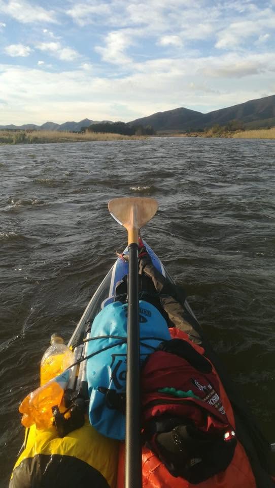 First-person view paddling toward distant mountains