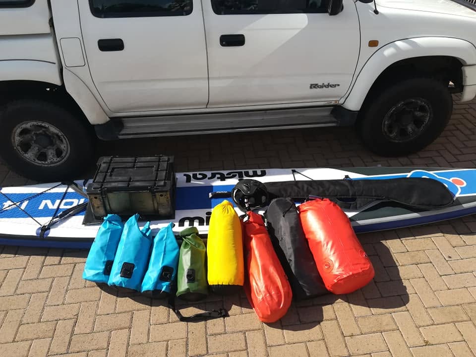 Fully packed SUP board loaded next to the vehicle before departure