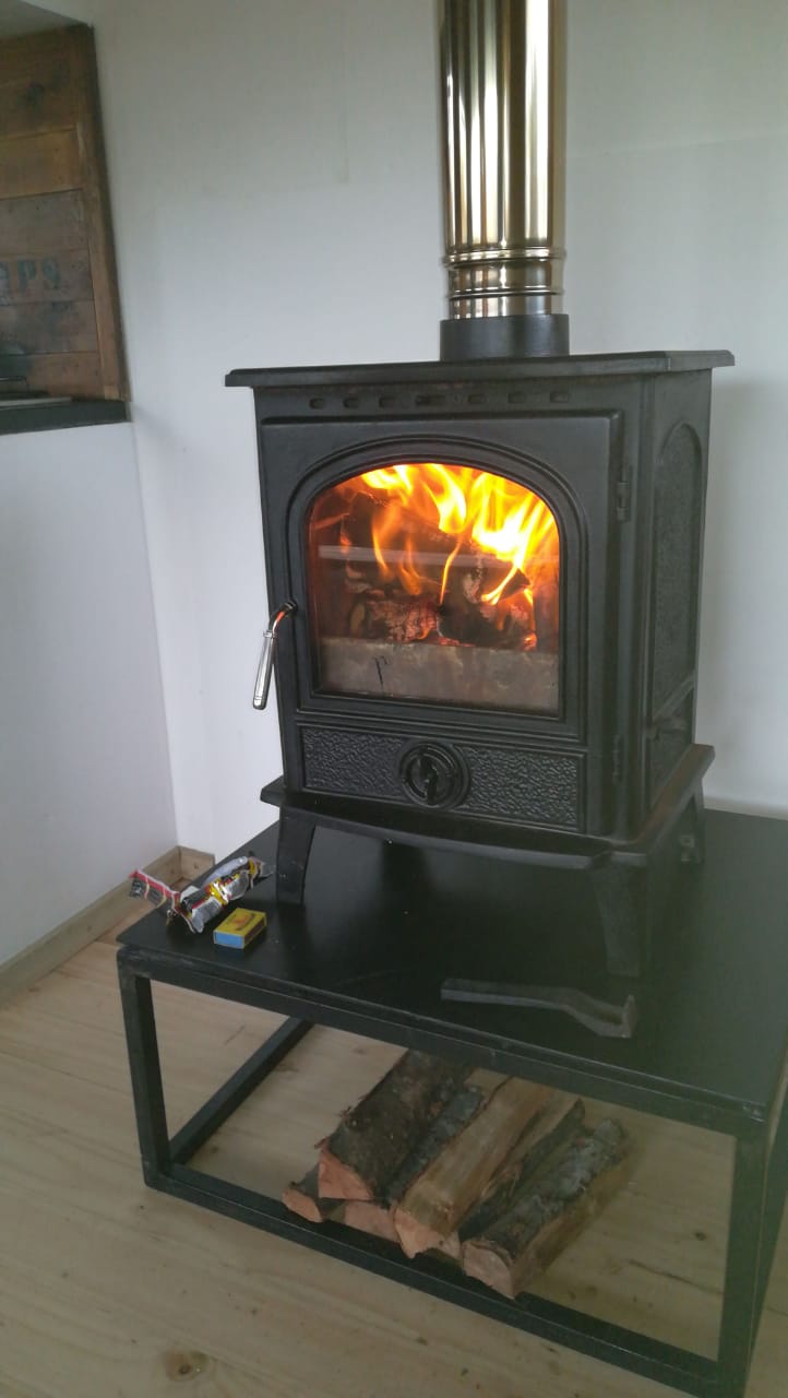A wood stove fire burning at the Kambathi overnight stop